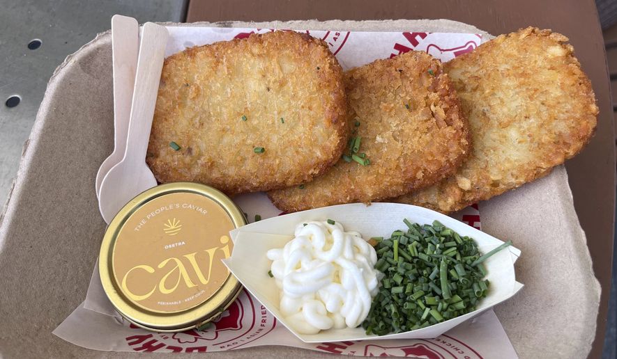 A $75 dish called “Fancy AF Tots” is shown containing fried hash brown potatoes, caviar, crème fraiche and chives at a World Cup match at Miami Stadium in Miami Gardens, Fla., Sunday, June 21, 2026. (AP Photo/Tim Reynolds)