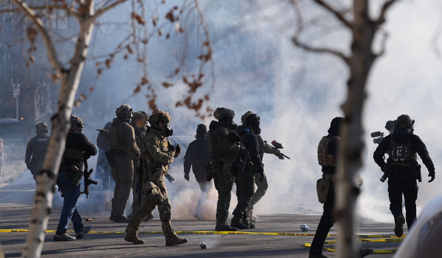 FILE - Federal immigration officers deploy tear gas at protesters after a shooting Jan. 24, 2026, in Minneapolis. (AP Photo/Abbie Parr, File)