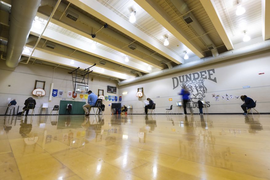 Voters cast their ballots at Dundee Elementary School in Omaha, Neb., on Election Day, Tuesday, Nov. 5, 2024. (AP Photo/Bonnie Ryan)