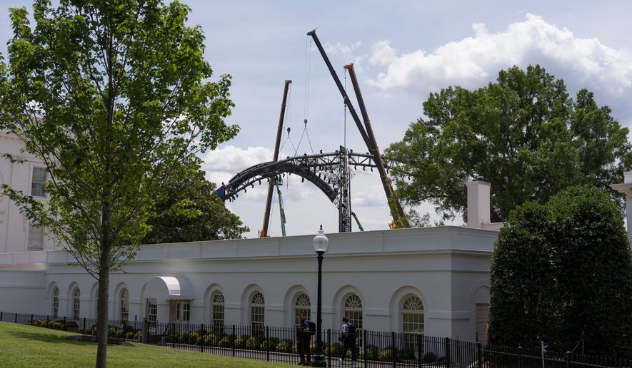 Crews work to disassemble the structure that was built for UFC Freedom 250 on the South Lawn of the White House, Sunday, June 21, 2026, in Washington. (AP Photo/Mark Schiefelbein)