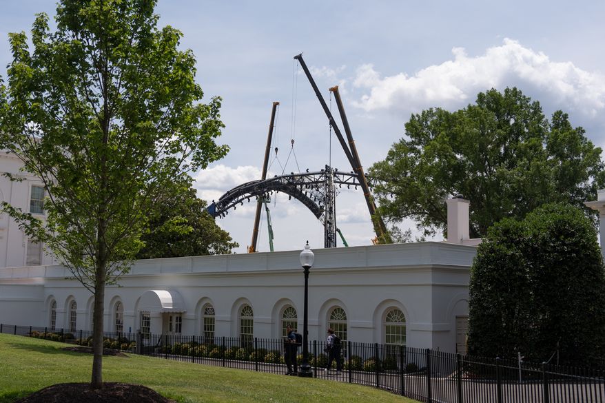 Crews work to disassemble the structure that was built for UFC Freedom 250 on the South Lawn of the White House, Sunday, June 21, 2026, in Washington. (AP Photo/Mark Schiefelbein)