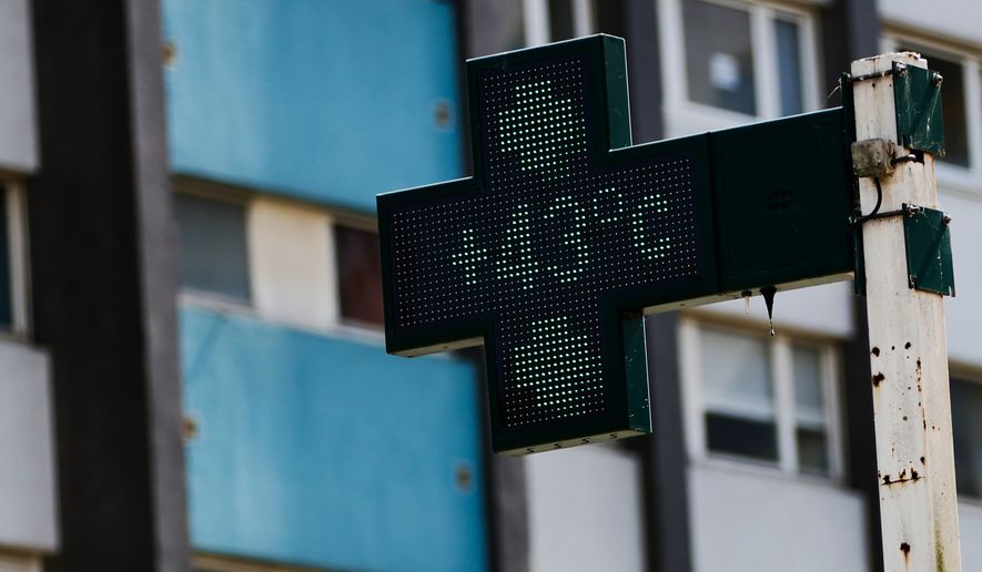A drugstore sign shows the temperature 43 degrees Celsius (109,4 degrees Fahrenheit) in Rennes, western France, Monday, June 22, 2026. (AP Photo/Jeremias Gonzalez)
