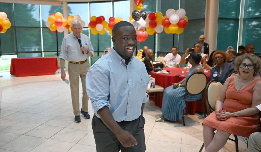 Adrian Boafo, a Maryland state delegate and candidate for U.S. Congress walks into the crowd after being introduced by Congressman Steny Hoyer, left, at the "AmeriPac Bull Roast" Friday, June 12, 2026, in Mitchellville, Md. (AP Photo/Gail Burton)