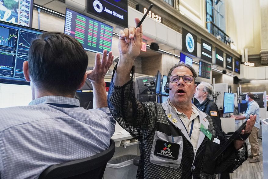 Options trader Anthony Spina, center, works on the floor of the New York Stock Exchange, Tuesday, June 16, 2026. (AP Photo/Richard Drew)