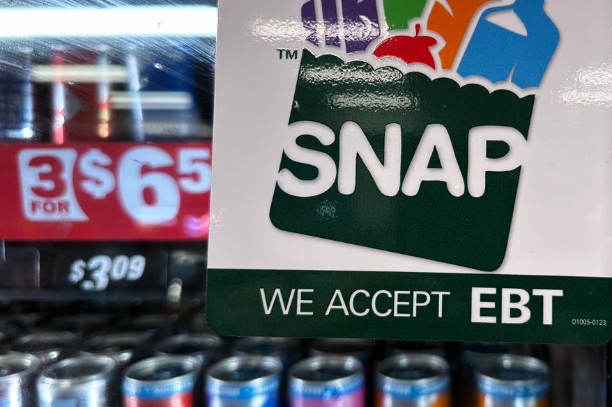 SNAP EBT information sign is displayed at a gas station in Riverwoods, Ill., Nov. 1, 2025. (AP Photo/Nam Y. Huh, File)