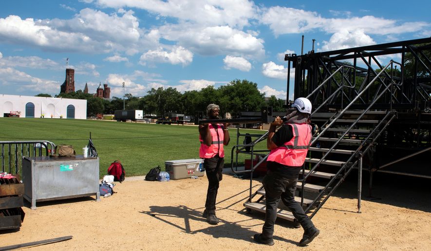 Workers build the stage for the Great American State Fair, on the National Mall in Washington, Wednesday, June 17, 2026. (AP Photo/Cliff Owen)
