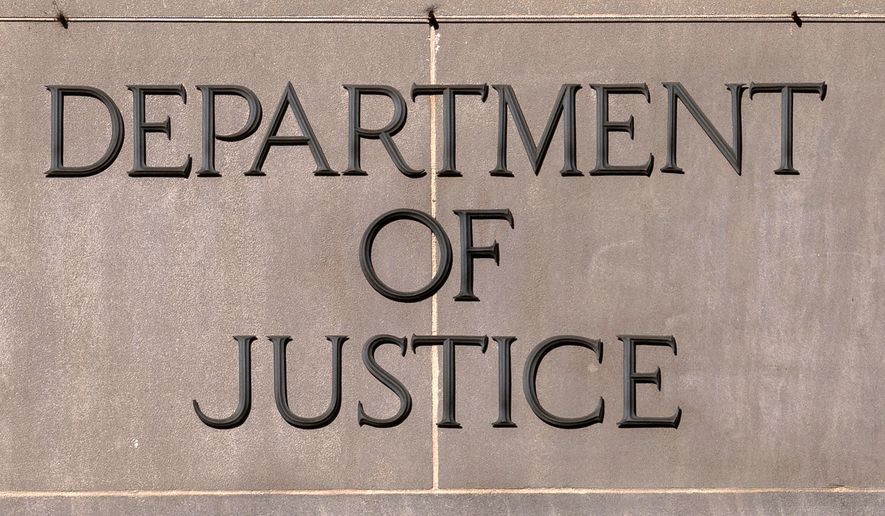 A sign of the U.S. Department of Justice is seen on the headquarters building in Washington, Nov. 18, 2024. (AP Photo/Jose Luis Magana, File)