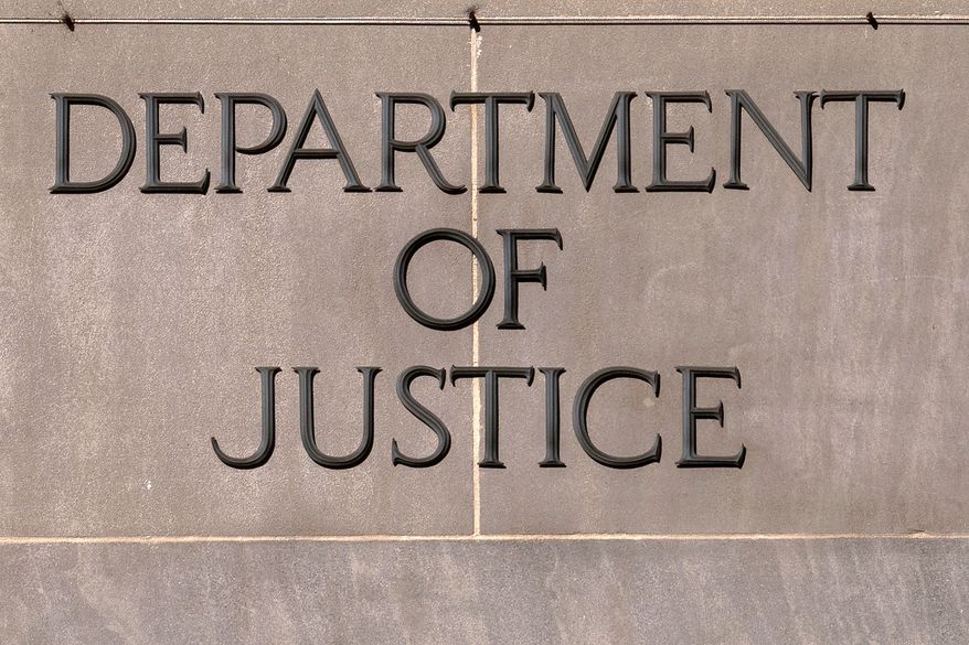 A sign of the U.S. Department of Justice is seen on the headquarters building in Washington, Nov. 18, 2024. (AP Photo/Jose Luis Magana, File)