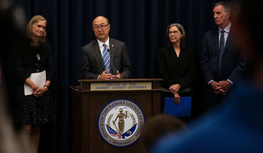 FILE - Ramsey County Attorney John Choi, at podium, discusses his office's review of former Ramsey County Medical Examiner Michael McGee's work during a news conference in St. Paul, Minn., Sept. 11, 2024.(John Autey/Pioneer Press via AP, File)