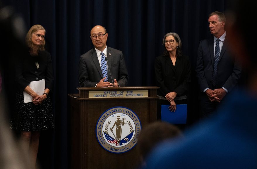 FILE - Ramsey County Attorney John Choi, at podium, discusses his office's review of former Ramsey County Medical Examiner Michael McGee's work during a news conference in St. Paul, Minn., Sept. 11, 2024.(John Autey/Pioneer Press via AP, File)