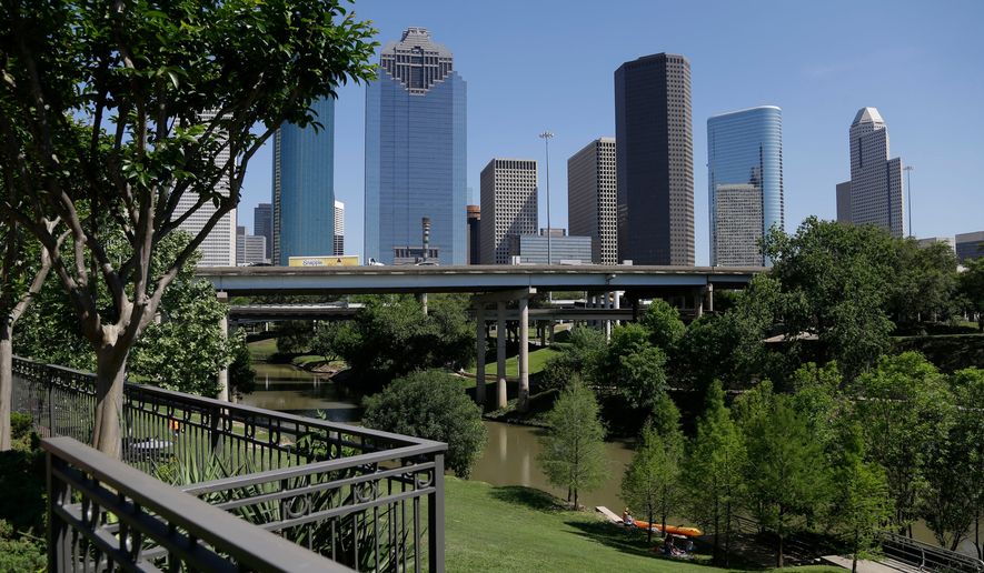 The Houston skyline overlooks the Buffalo Bayou as it snakes its way into downtown April 18, 2014. (AP Photo/Pat Sullivan, File)