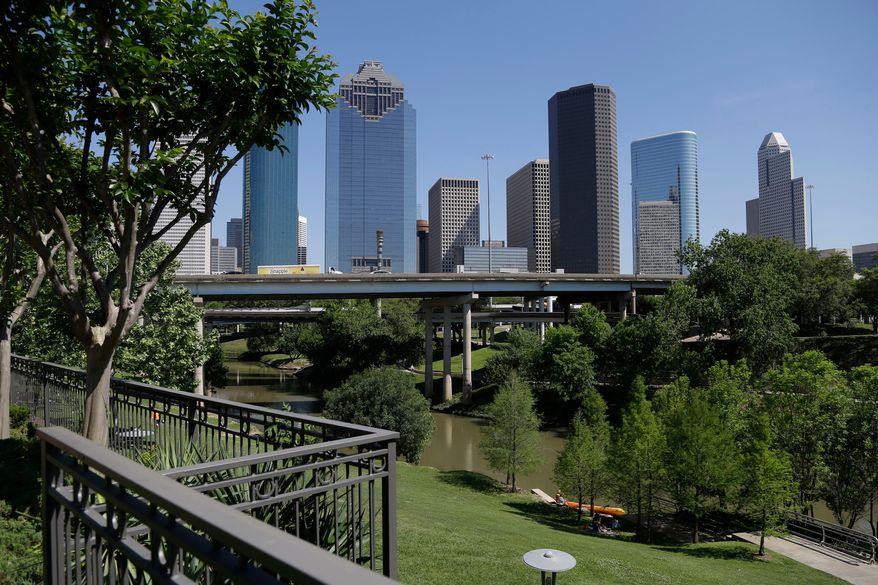 The Houston skyline overlooks the Buffalo Bayou as it snakes its way into downtown April 18, 2014. (AP Photo/Pat Sullivan, File)