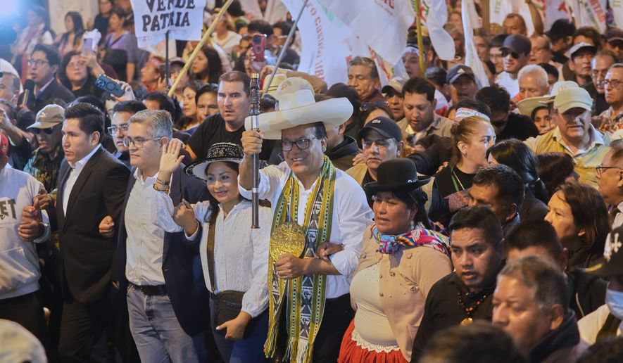 Presidential candidate Roberto Sanchez of the Together for Peru party, center, walks with supporters during a protest against presidential candidate Keiko Fujimori of the Popular Force party in Lima, Peru, Friday, June 19, 2026. (AP Photo/Miguel Paredes)