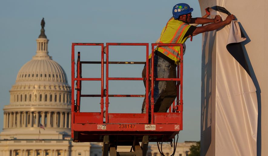 Preparation continues for the Great American State Fair on the National Mall, Sunday, June 21, 2026, in Washington. (AP Photo/Jon Elswick