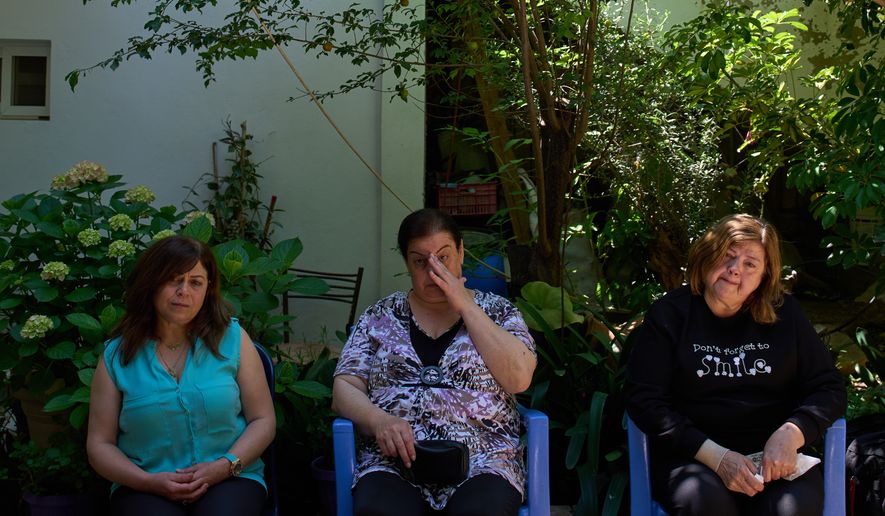 From left, Lolitta Costantine, Wadiaa Salloum, and Marie Salloum sit outside Costantine's home in the southern town of Jdeidat Marjayoun, Lebanon, Thursday, June 11, 2026. (AP Photo/Hassan Ammar) CORRECTION: City corrected to Jdeidat Marjayoun, instead of Marjayoun.