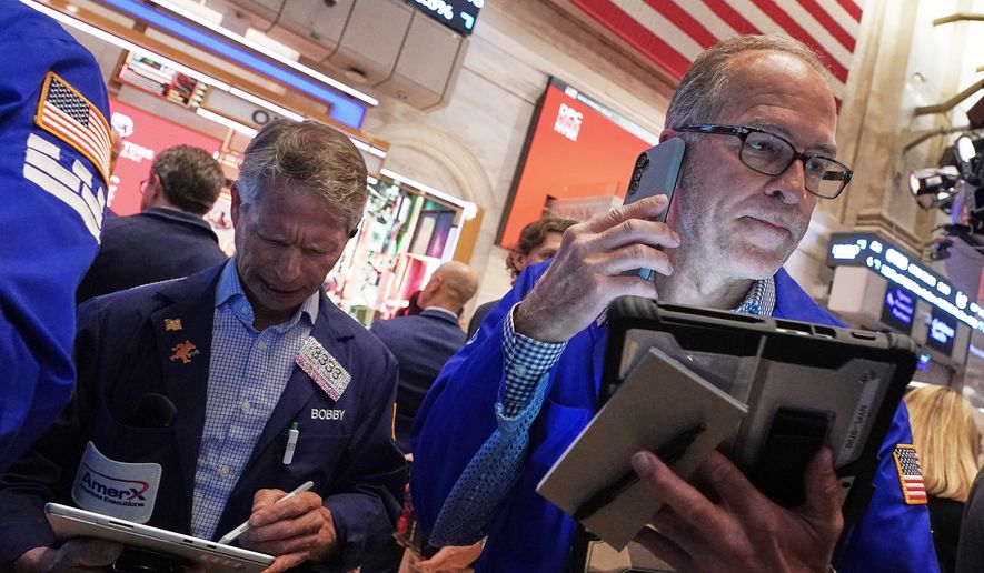 Traders Robert Charmak, left, and Mark Puetzer work on the floor of the New York Stock Exchange, Thursday, June 25, 2026. (AP Photo/Richard Drew)
