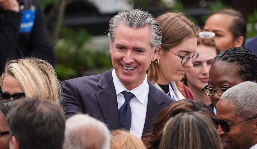 California Gov. Gavin Newsom mingles ahead of the Obama Presidential Center dedication ceremony Thursday, June 18, 2026, in Chicago. (AP Photo/Jeff Roberson) ** FILE **