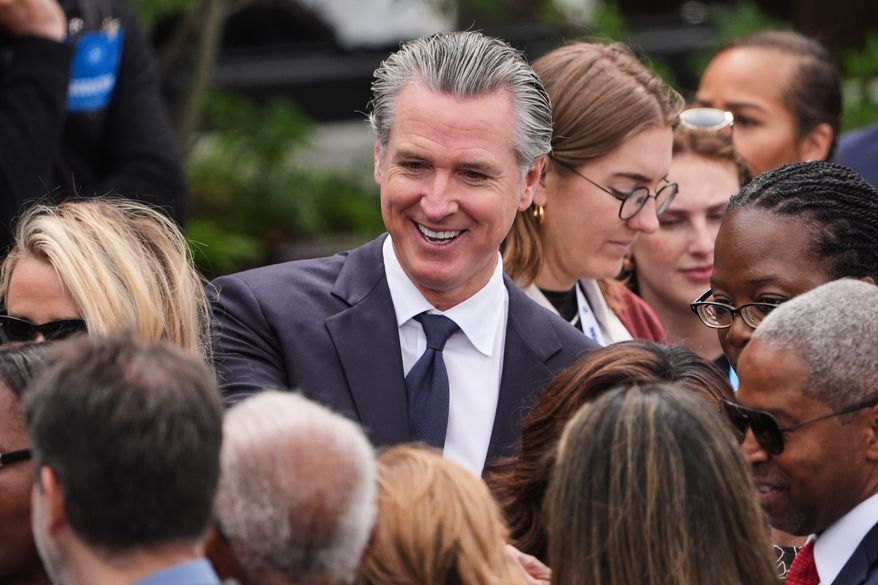 California Gov. Gavin Newsom mingles ahead of the Obama Presidential Center dedication ceremony Thursday, June 18, 2026, in Chicago. (AP Photo/Jeff Roberson) ** FILE **