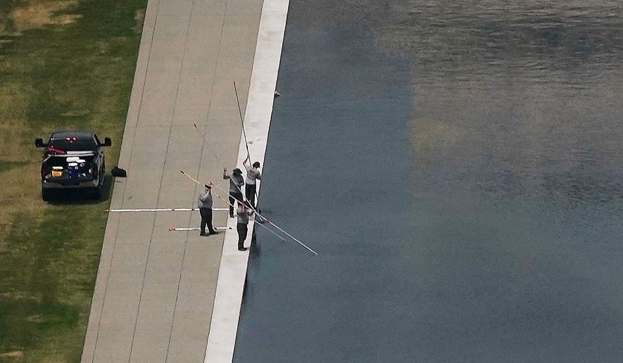 Personnel work on the Lincoln Memorial Reflecting Pool near the base of the Lincoln Memorial, Friday, June 26, 2026, in Washington. (AP Photo/Carolyn Kaster)
