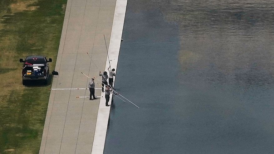 Personnel work on the Lincoln Memorial Reflecting Pool near the base of the Lincoln Memorial, Friday, June 26, 2026, in Washington. (AP Photo/Carolyn Kaster)