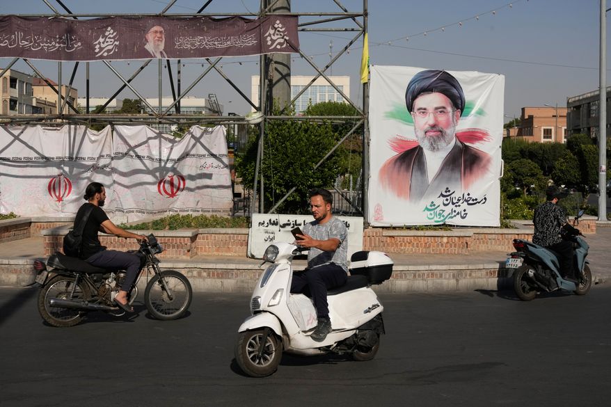Motorbikes drive past a banner showing a portrait of the Iranian Supreme Leader Ayatollah Mojtaba Khamenei in downtown Tehran, Iran, Monday, June 29, 2026. (AP Photo/Vahid Salemi)