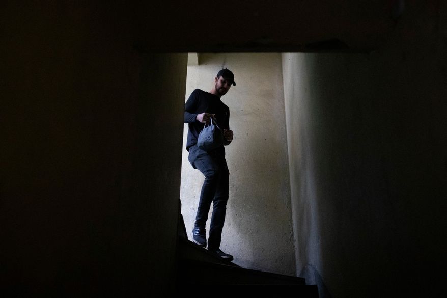 Matheus Paulo da Costa Silva leaves home for work in Rio de Janeiro, Friday, May 29, 2026. (AP Photo/Bruna Prado)