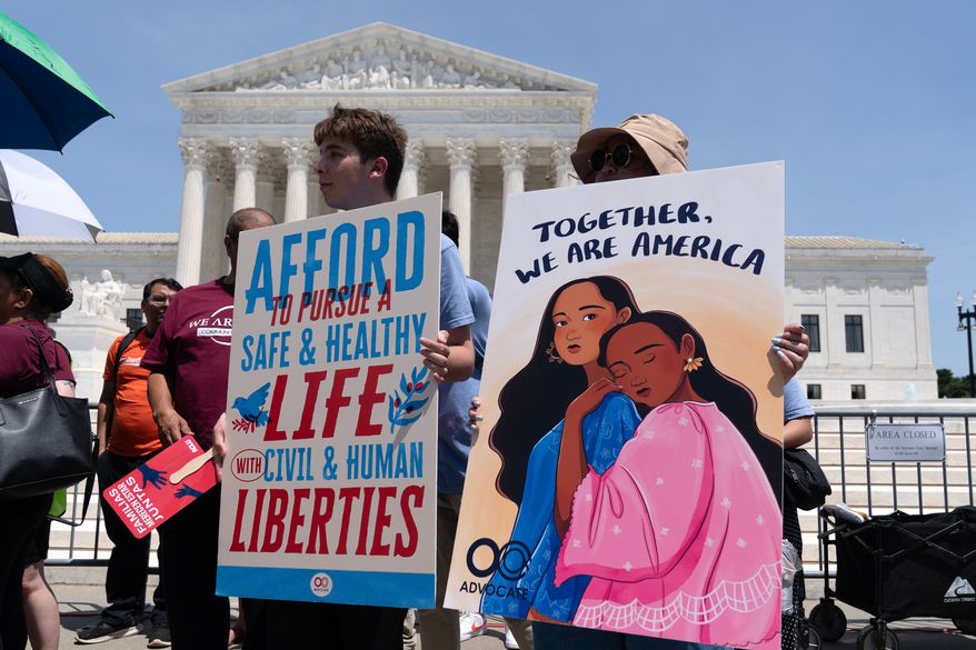 Activists celebrate the Supreme Court's ruling on birthright citizenship, outside of the Supreme Court on Capitol Hill, Tuesday, June 30, 2026, in Washington. (AP Photo/Jose Luis Magana)