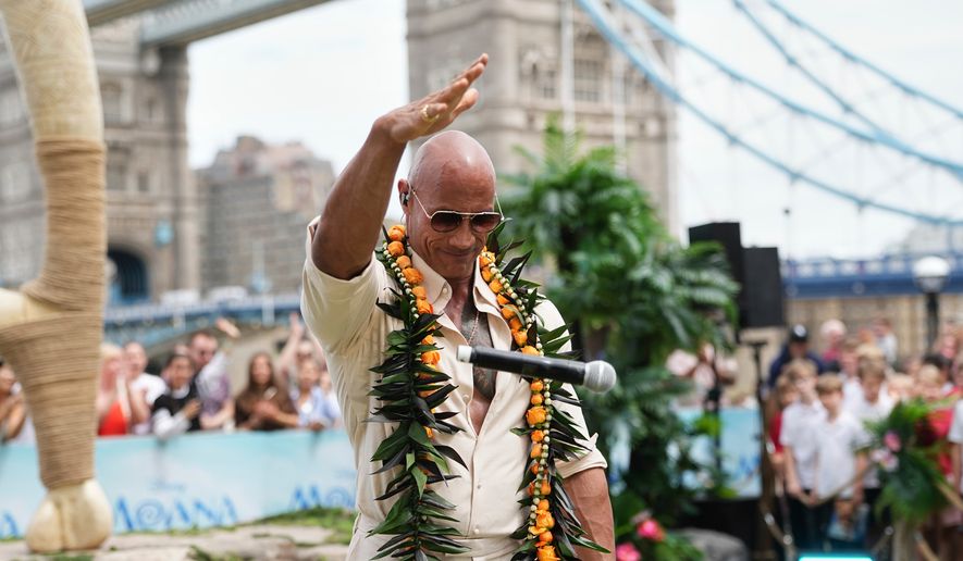 Dwayne Johnson drops the microphone at the "Moana" experience in London, Tuesday, June 30, 2026. (Photo by Scott Garfitt/Invision/AP)