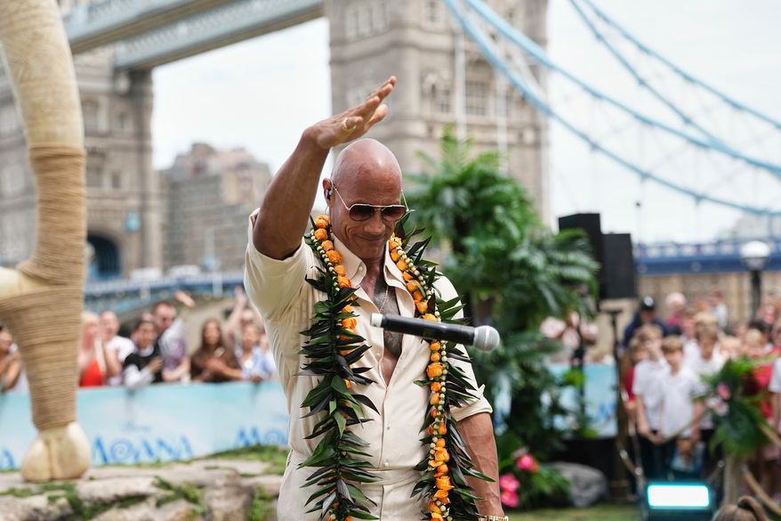 Dwayne Johnson drops the microphone at the "Moana" experience in London, Tuesday, June 30, 2026. (Photo by Scott Garfitt/Invision/AP)