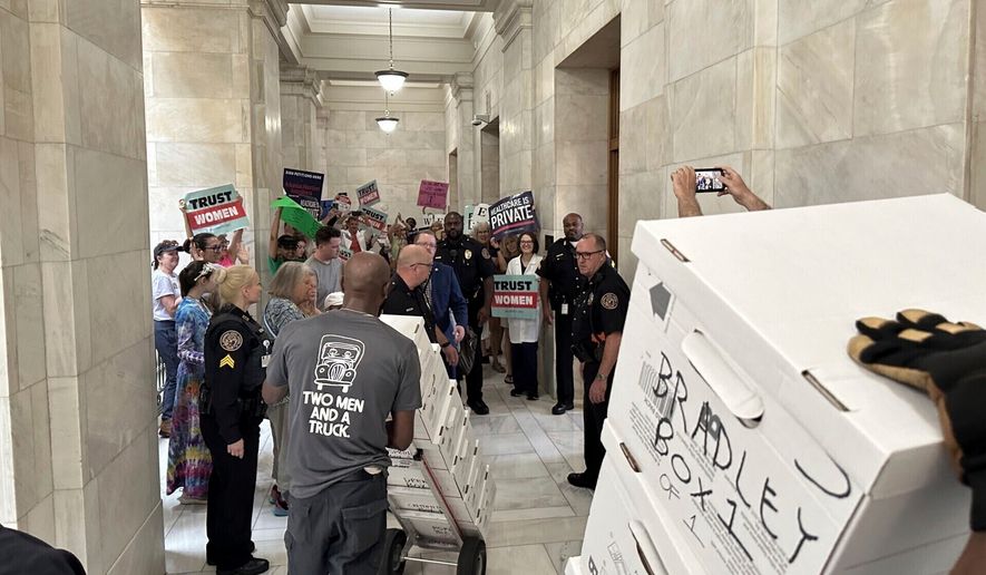 FILE - Boxes containing signatures supporting a proposed ballot measure to scale back Arkansas' abortion ban are delivered to a room in the state Capitol, July 5, 2024, in Little Rock, Ark. (AP Photo/Andrew DeMillo, File)