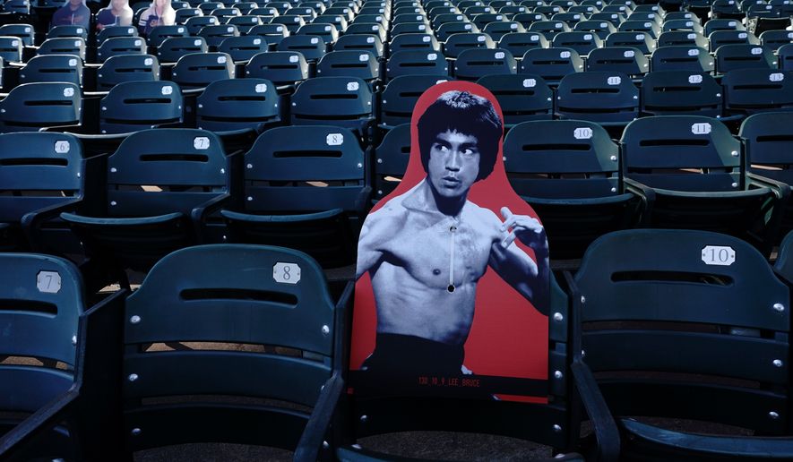 A cardboard cutout of martial artist Bruce Lee is displayed at Oracle Park before a baseball game between the San Francisco Giants and the San Diego Padres in San Francisco, July 30, 2020. (AP Photo/Jeff Chiu, File)