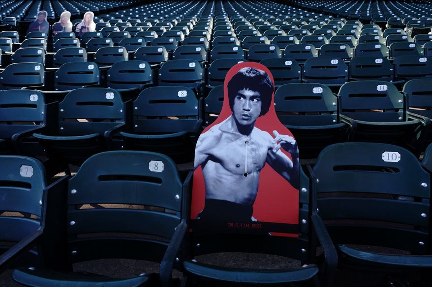 A cardboard cutout of martial artist Bruce Lee is displayed at Oracle Park before a baseball game between the San Francisco Giants and the San Diego Padres in San Francisco, July 30, 2020. (AP Photo/Jeff Chiu, File)