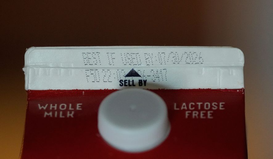 A Best If Used By date is stamped above a Sell By label on a milk carton, Tuesday, June 30, 2026, in San Francisco. (AP Photo/Jeff Chiu)