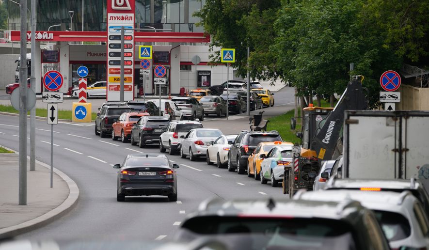 Cars line up at a Lukoil gas station in Moscow, Monday, June 29, 2026. (AP Photo/Pavel Bednyakov)