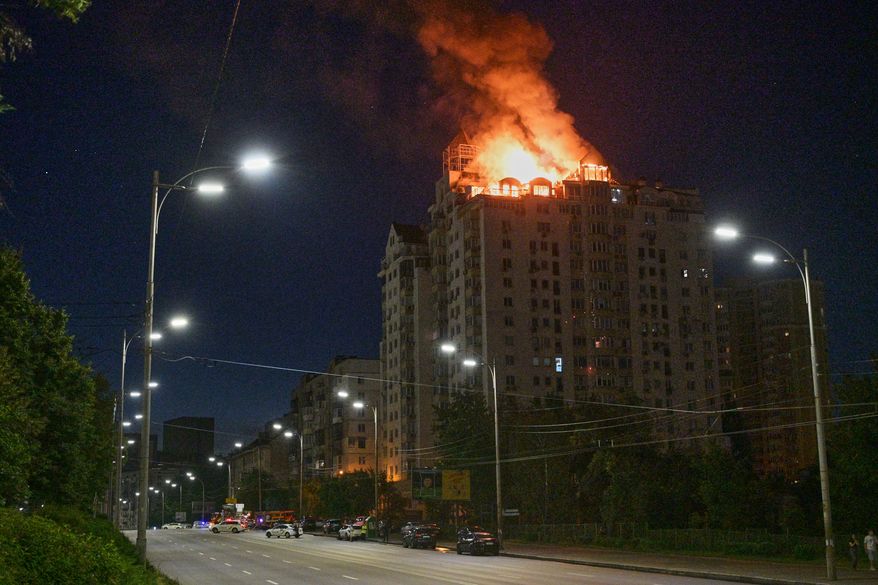 An apartment building burns after a Russian missile attack in Kyiv, Ukraine, Thursday, July 2, 2026. (AP Photo/Danylo Antoniuk)