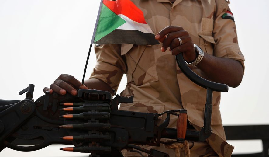FILE - A Sudanese soldier from the Rapid Support Forces or RSF stands on his vehicle in the East Nile province, Sudan, on June 22, 2019. (AP Photo/Hussein Malla, File)