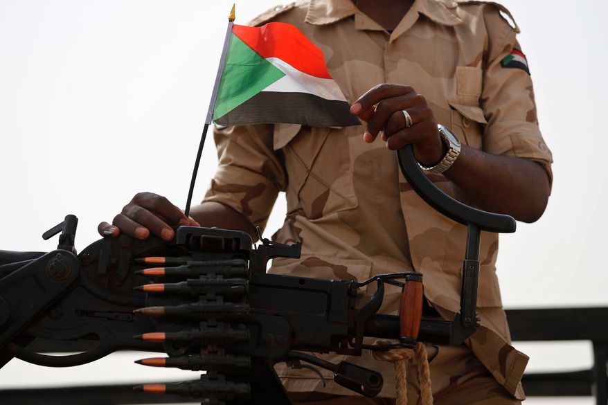 FILE - A Sudanese soldier from the Rapid Support Forces or RSF stands on his vehicle in the East Nile province, Sudan, on June 22, 2019. (AP Photo/Hussein Malla, File)