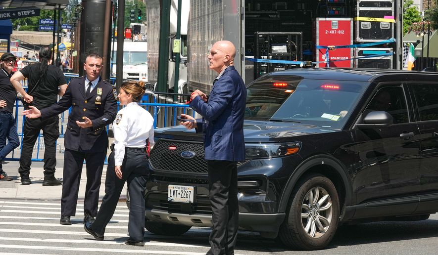 Security personnel meet outside New York's Madison Square Garden, Wednesday, July 1, 2026. (AP Photo/Richard Drew)