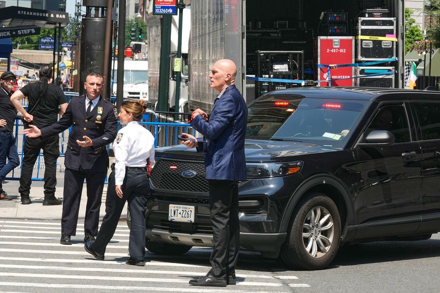 Security personnel meet outside New York's Madison Square Garden, Wednesday, July 1, 2026. (AP Photo/Richard Drew)