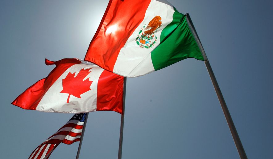 FILE - National flags representing the United States, Canada, and Mexico fly in the breeze in New Orleans where leaders of the North American Free Trade Agreement met on April 21, 2008. (AP Photo/Judi Bottoni, File)