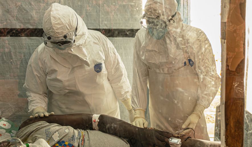 FILE - Health workers attend to an Ebola patient at the Rwampara treatment Center in Ituri, Congo, Thursday, June 18, 2026. (AP Photo/Moses Sawasawa, file)