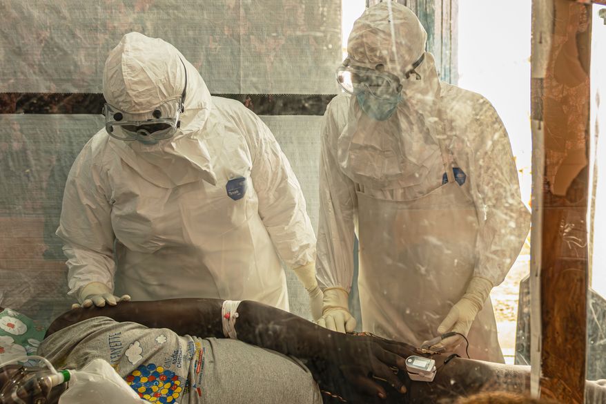 FILE - Health workers attend to an Ebola patient at the Rwampara treatment Center in Ituri, Congo, Thursday, June 18, 2026. (AP Photo/Moses Sawasawa, file)