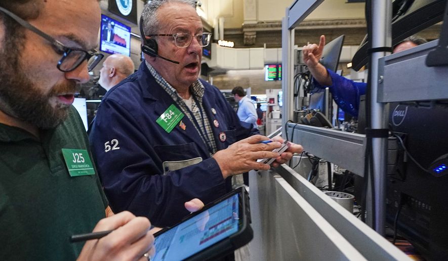 Options traders Serge Marinovich, left, and Phil Phil Fracassini work on the floor of the New York Stock Exchange, Friday, June 26, 2026. (AP Photo/Richard Drew)