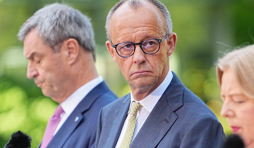 German Federal Chancellor Friedrich Merz, center, attends a press conference with Minister-President of Bavaria and CSU Chairman Markus Söder, left, Federal Minister of Labor and Social Affairs Bärbel Bas, right and Federal Minister of Finance, Lars Klingbeil, in the garden of the Chancellery following the meeting of the coalition committee, in Berlin, Thursday, July 2, 2026. (Michael Kappeler/dpa via AP)
