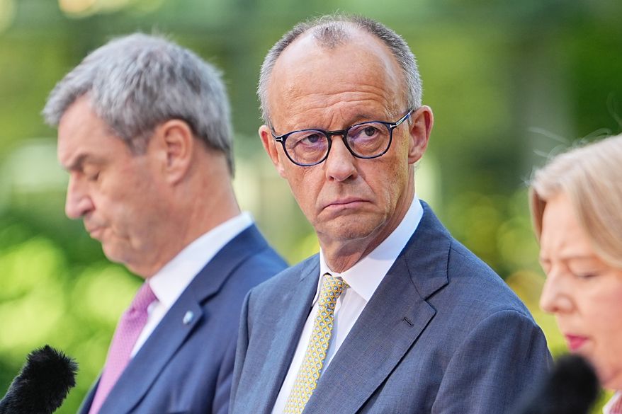German Federal Chancellor Friedrich Merz, center, attends a press conference with Minister-President of Bavaria and CSU Chairman Markus Söder, left, Federal Minister of Labor and Social Affairs Bärbel Bas, right and Federal Minister of Finance, Lars Klingbeil, in the garden of the Chancellery following the meeting of the coalition committee, in Berlin, Thursday, July 2, 2026. (Michael Kappeler/dpa via AP)
