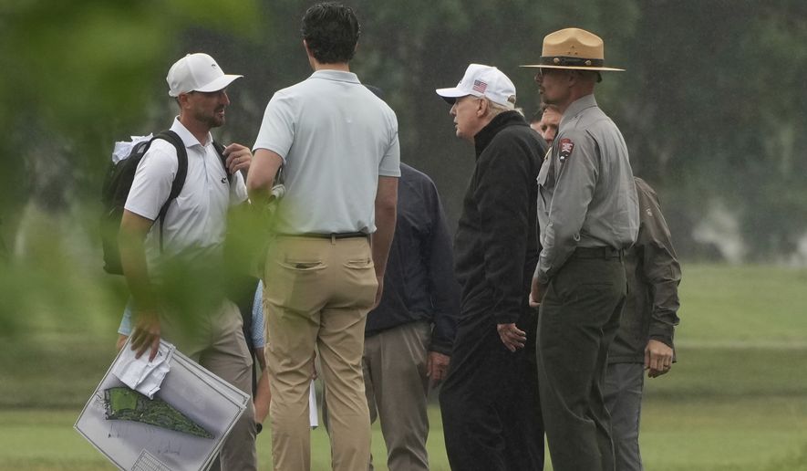 President Donald Trump, second right, tours the East Potomac Park golf course alongside a person carrying blueprints, Sunday, June 28, 2026, in Washington. (AP Photo/Mark Schiefelbein)