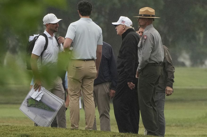 President Donald Trump, second right, tours the East Potomac Park golf course alongside a person carrying blueprints, Sunday, June 28, 2026, in Washington. (AP Photo/Mark Schiefelbein)