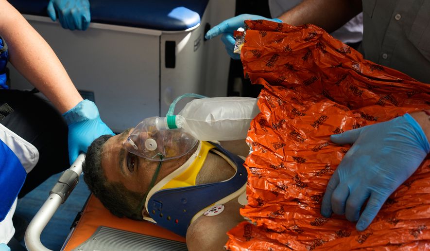 Rescue workers carry Alberto Gil after he was pulled from the rubble a week after he was trapped by twin earthquakes that struck Catia La Mar, Venezuela. in Catia La Mar, Venezuela, Thursday, July 2, 2026. (AP Photo/Fernando Vergara)