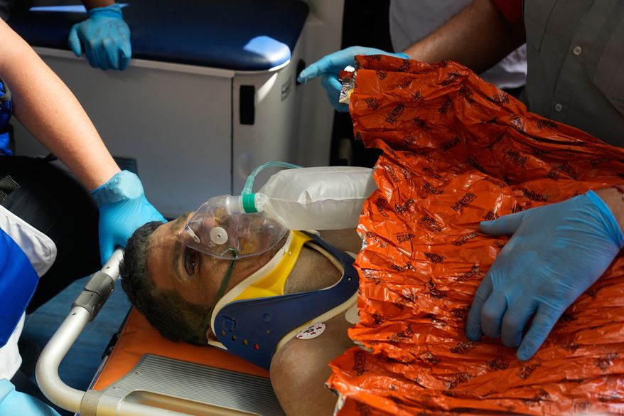Rescue workers carry Alberto Gil after he was pulled from the rubble a week after he was trapped by twin earthquakes that struck Catia La Mar, Venezuela. in Catia La Mar, Venezuela, Thursday, July 2, 2026. (AP Photo/Fernando Vergara)