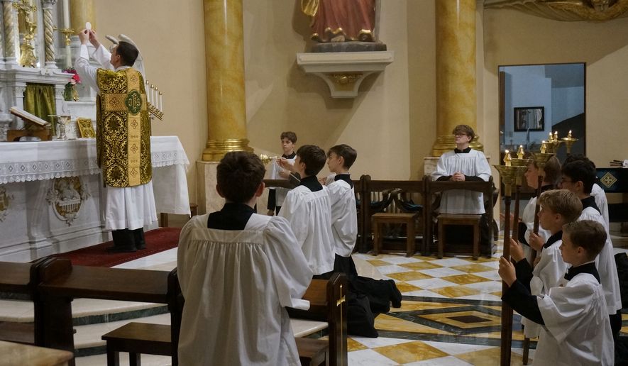 The Rev. John Ubel, pastor of the Church of Saint Agnes, celebrates the eucharistic prayer facing the altar, in the traditional custom, during one of the Catholic parish’s Latin Masses in St. Paul, Minn., Sunday, June 28, 2026. (AP Photo/Giovanna Dell’Orto)
